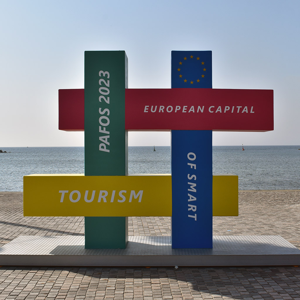 A statue featuring a multicoloured hashtag decorated with text saying Pafos 2023 European Capital of Smart Tourism